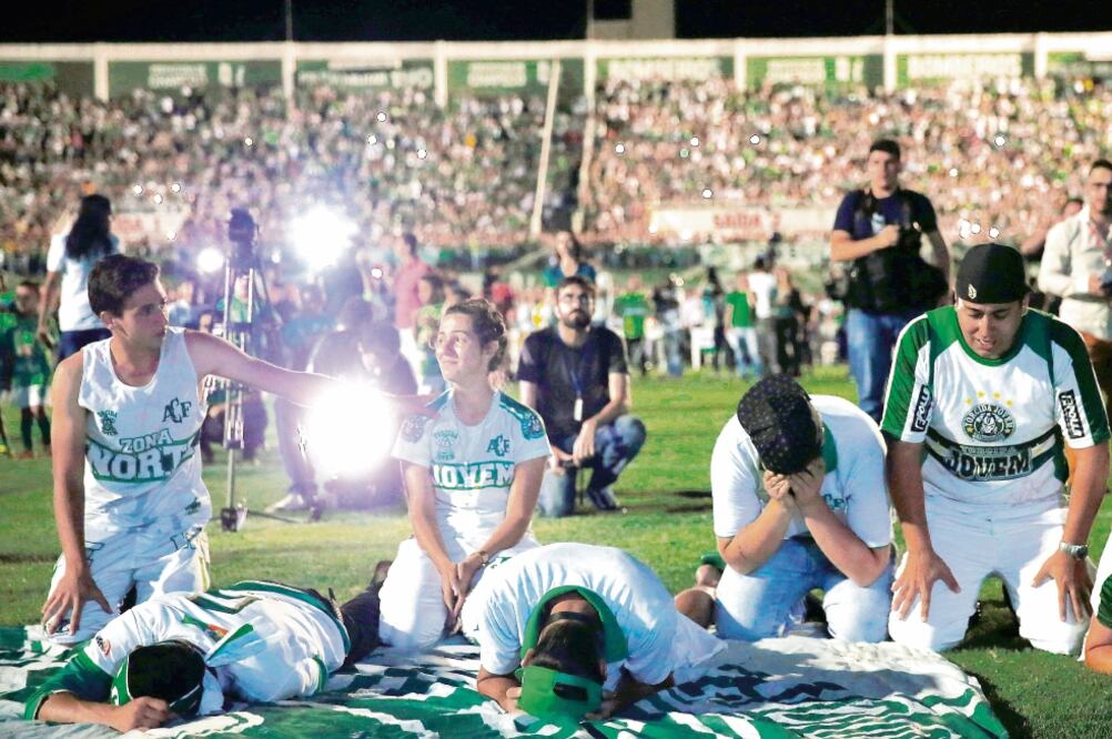 Fanáticos del Chapecoense, dolientes en el Arena Conda. (FOTO: RICARDO MORAES. REUTERS)