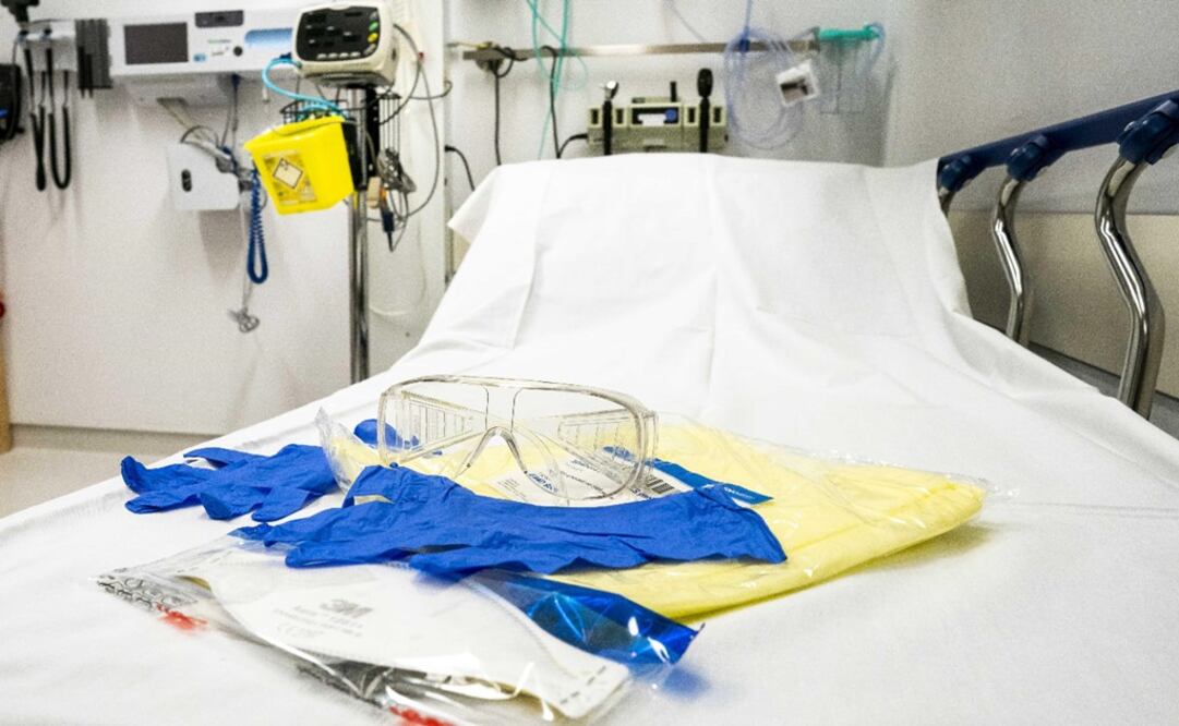 Protective equipment, face shield, splash goggles, plastic gloves, lie on a bed in the isolation room at UMC Utrecht University hospital in Utrecht, The Netherlands, 30 January 2020 - Photo: Jerry Lampen/EFE