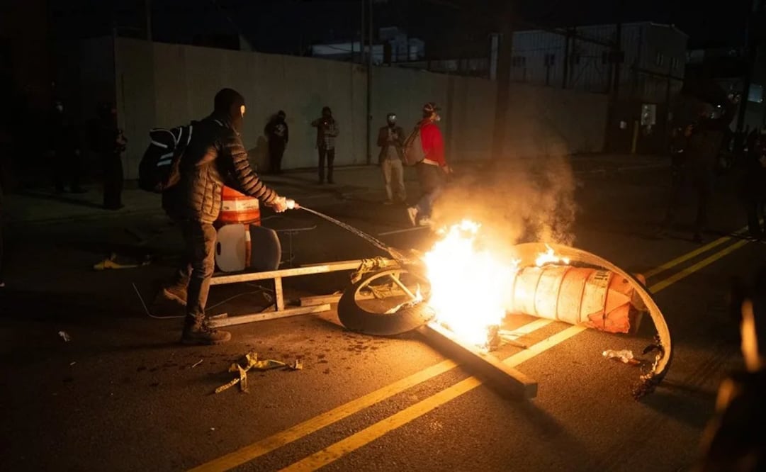 Vista de personas que encienden fuego durante una protesta ante un centro de detención de migrantes de Newark, Nueva Jersey (EU), el 30 de mayo de 2026. Foto: EFE