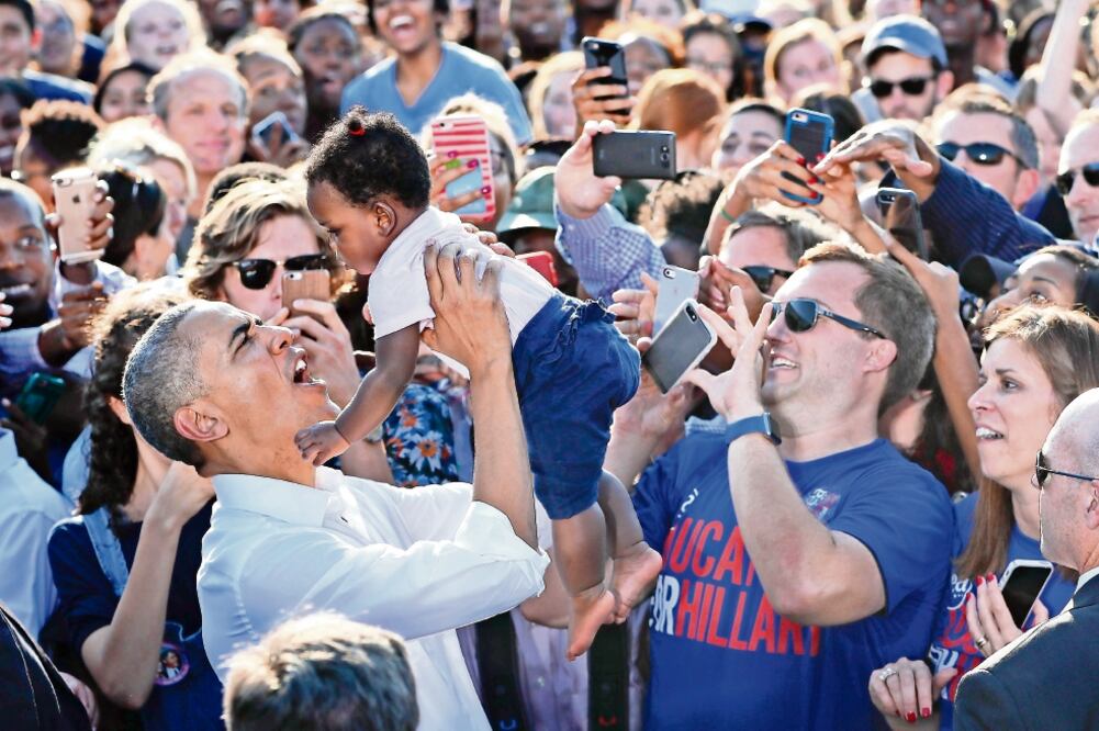 El presidente Barack Obama carga a un niño durante un mitin ayer en Carolina del Norte (PABLO MARTINEZ MONSIVAIS. AP)