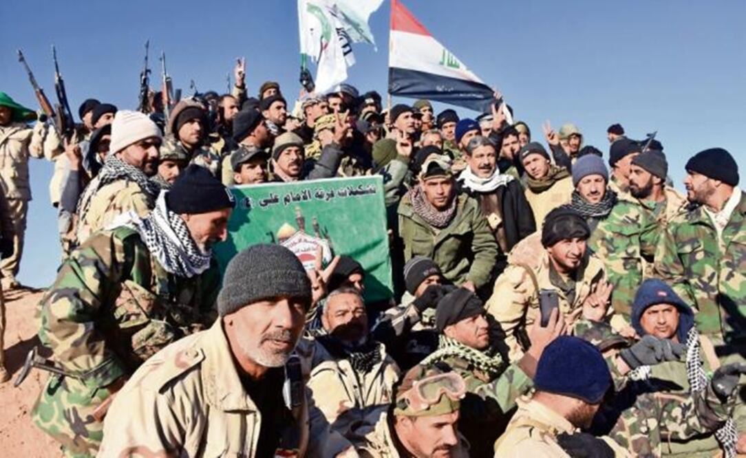 Members of the Imam Ali Division celebrating the declaration of the Iraq government on their triymph against the terrorist group – Photo by AFP