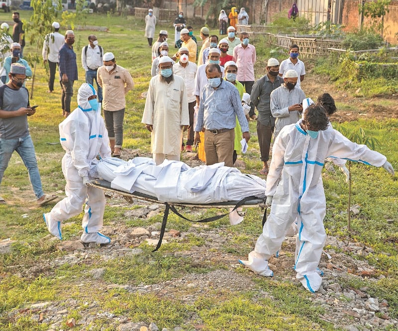 Los trabajadores municipales se preparan para enterrar el cuerpo de una persona que murió por Covid-19 en Gauhati, India. Foto: ANUPAM NATH. AP