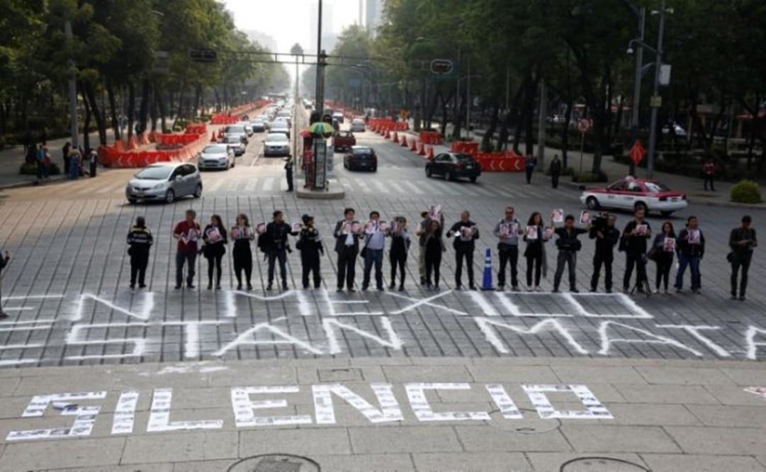 Journalists and photographers protest at the Angel of Independence Monument, Mexico City, where they have wrote  "We are being killed in Mexico", while photos of journalists slain this year form the words "No to Silence"- Photo: Henry Romero/REUTERS