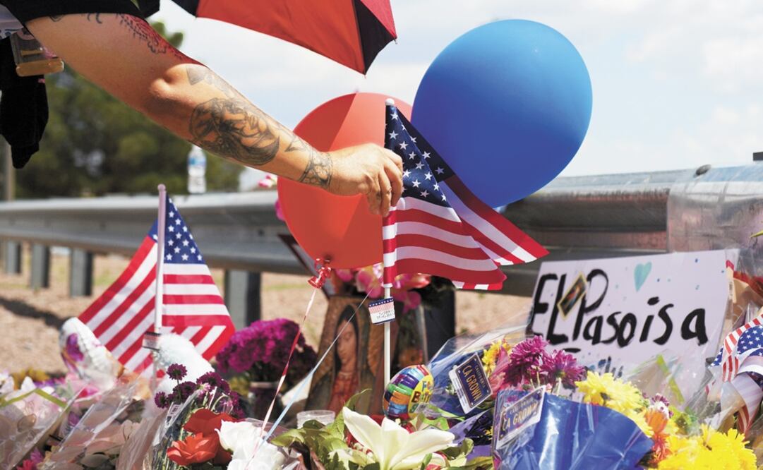 A man places an American flag in the pile of flowers that has gathered a day after a mass shooting at El Paso, Texas – Photo: Callaghan O'Hare/REUTERS