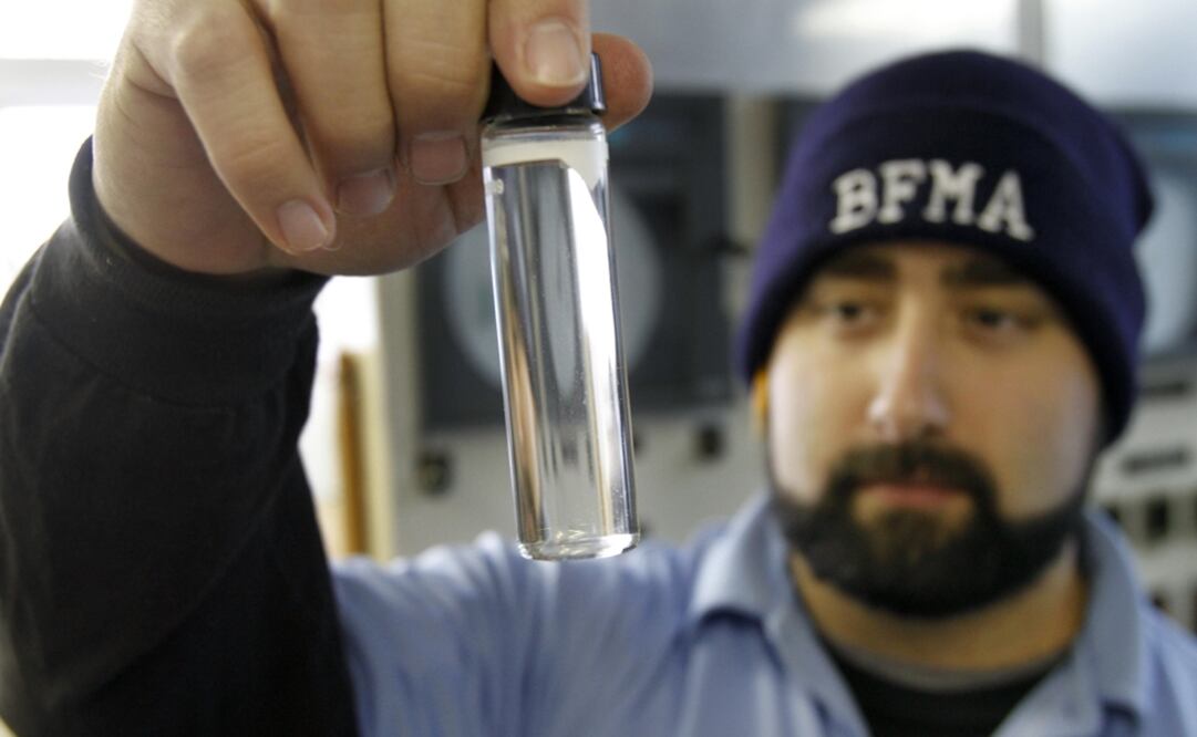 Water plant operator Torrey Jones checks the clarity of a sample of treated water at the Beaver Falls Municipal Authority water treatment plant - Photo: Keith Srakocic/AP