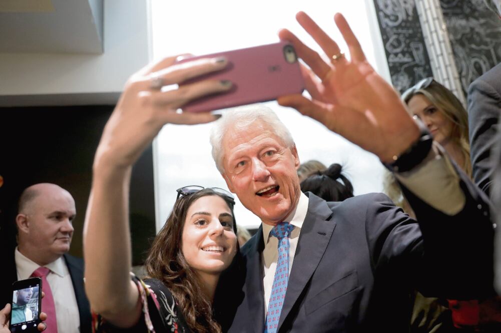 La generación millennial tiene una preferencia por la candidata del Partido Demócrata, Hillary Clinton. En la imagen, una joven posa para una selfie con el ex presidente Bill Clinton el pasado 13 de septiembre en Los Ángeles, California (JAE C. HONG. AP)