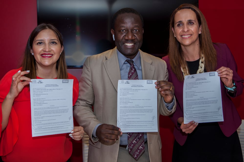 Tania Martínez García (L), Guy Djoken (C) and Graciela Rojas (R), display the MoU signed yesterday in Mexico City, as part of UNESCO's partnership with Mexico NGOs.