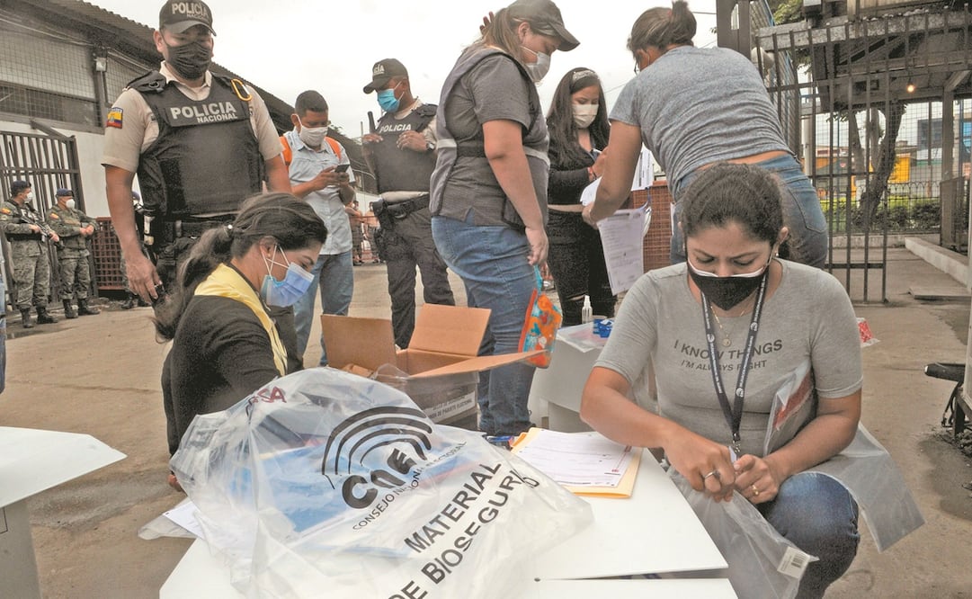 Ciudadanos alistan el material para los comicios, afuera del Consejo Nacional Electoral, en Guayaquil. Con 16 postulantes a la presidencia para gobernar por cuatro años, tres candidatos surgieron como favoritos. Foto: José Sánchez Lindao. AFP
