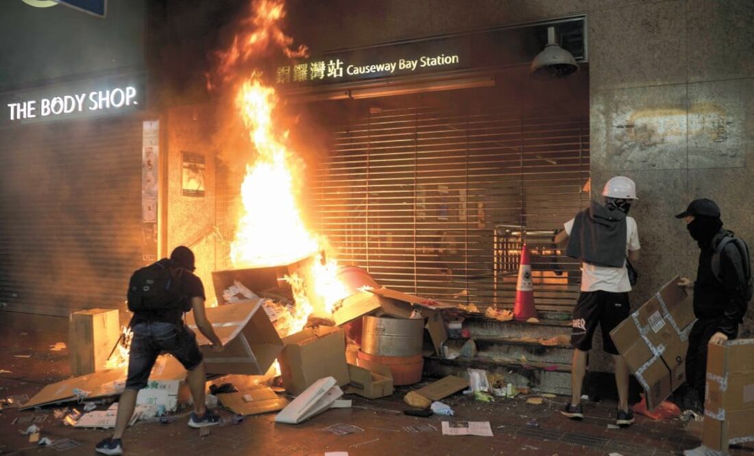 Manifestantes quemaron cajas de cartón en la entrada de la estación Causeway Bay, del Metro en Hong Kong. Los incidentes no tardaron en agravarse y la policía utilizó gas lacrimógeno. Foto: FELIPE DANA. AP