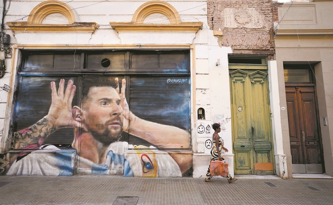 Una argentina frente a un mural de la estrella del futbol Lionel Messi, pintado por el artista peruano Mario Abad Causi en Buenos Aires. Foto: Natacha Pisarenko / AP