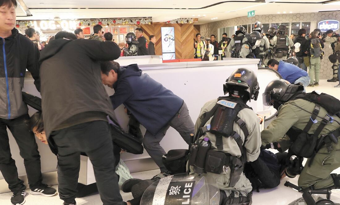Agentes antidisturbio detienen a un manifestante en un centro comercial, en Sha Tin, Hong Kong. LUCY NICHOLSON. REUTERS