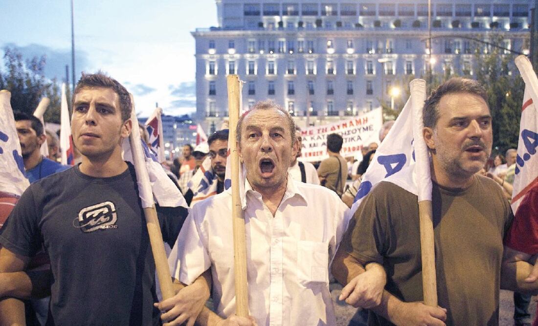 Miles de griegos salieron a las calles ayer para rechazar el rescate. En la foto, gente cercana al sindicato comunista PAME protesta frente al Parlamento (ALEXANDROS VLACHOS. EFE)