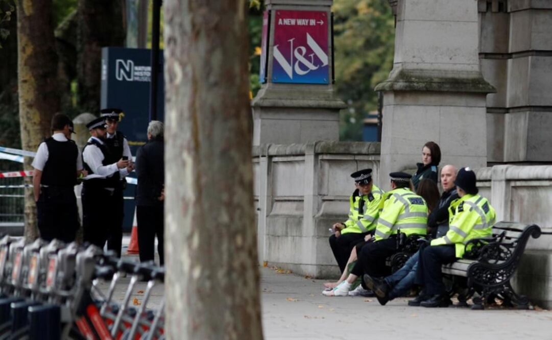 Police officers stand next to a person with a bandaged ankle near the Natural History Museum, after a car mounted the pavement – Photo: Peter Nicholls