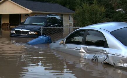 Swollen river feeds flooding near Houston as residents flee