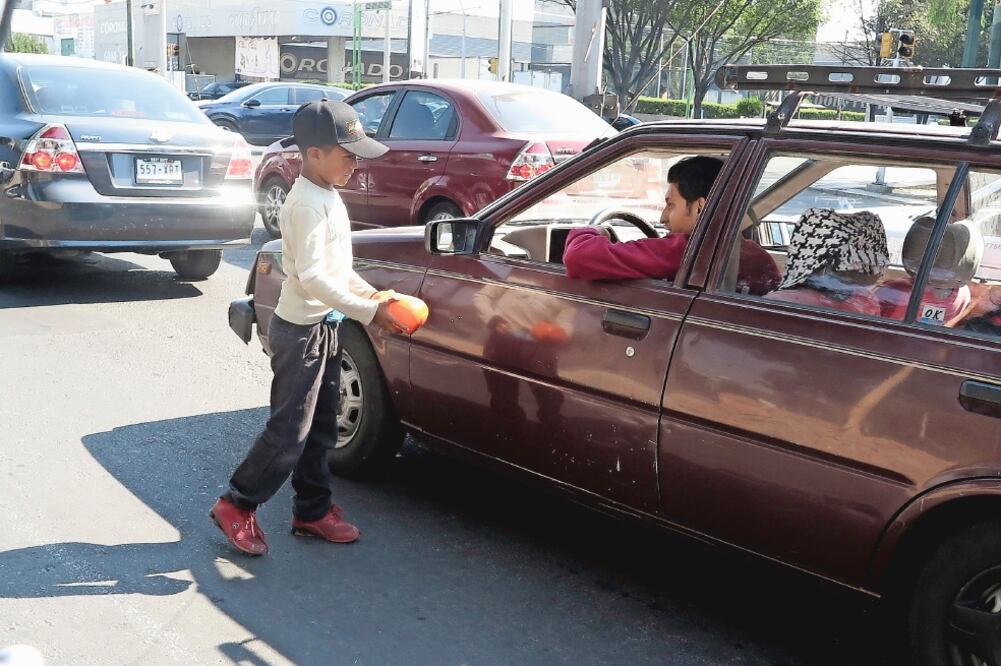 Sin festejo. Menores que realizan actividades en cruceros, sobre todo a lo largo de Reforma, se acercaban a conductores para pedirles sus Reyes. (LUIS CORTÉS. EL UNIVERSAL)
