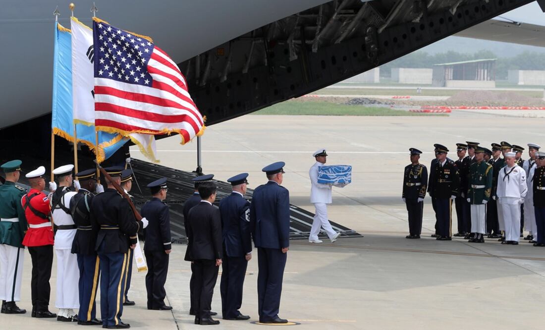 Un soldado estadounidense lleva una caja que contiene restos de soldados estadounidenses asesinados en la Guerra de Corea de 1950-53, afuera del Globemaster C-17. FOTO: EFE
