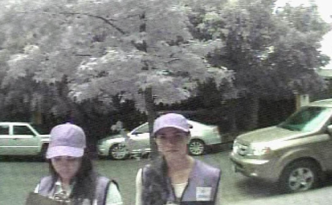 Captura de pantalla del video de seguridad que muestra a dos mujeres disfrazadas antes de entrar al domicilio que robaron