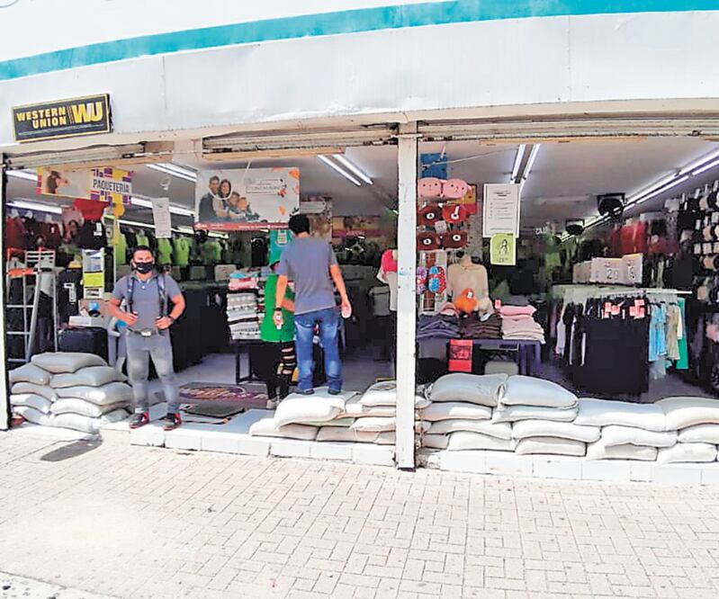 Comerciantes se previenen contra inundaciones colocando sacos de arena en la entrada de sus locales. FOTOS: LEOBARDO PÉREZ. EL UNIVERSAL