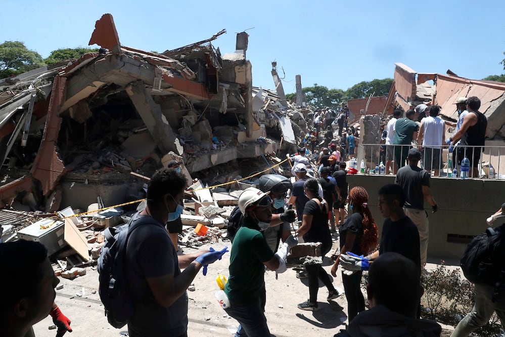 Bomberos y volunarios buscan entre los escombros de edificaciones colapsadas en Cali por el terremoto que sacudió Colombia. FOTO: ERNESTO GUZMÁN JR. EFE