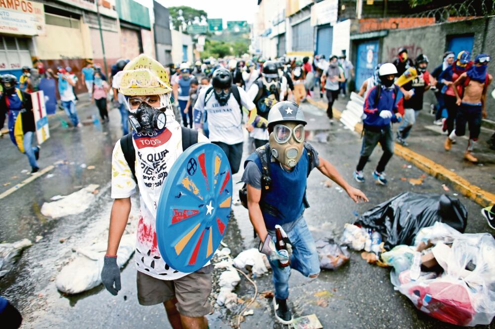 Manifestantes opositores se enfrentaron ayer a miembros de la Guardia Nacional en la “Toma de Caracas”, contra la Constituyente de Nicolás Maduro (ARIANA CUBILLOS. AP)