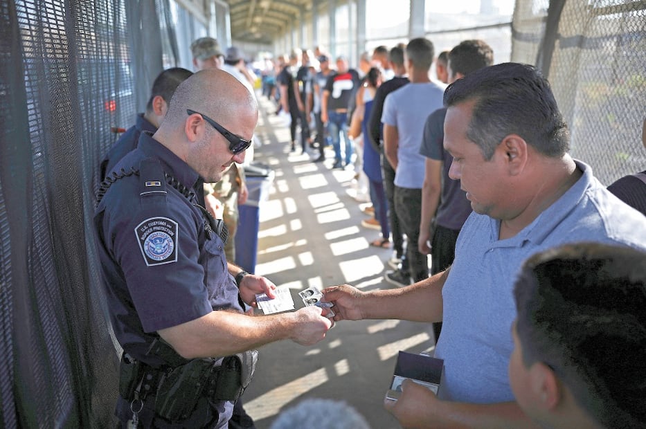 Revisión. Un agente fronterizo verifica la visa de un hombre en el puente Puerta México. Foto: MILIO ESPEJEL. AP