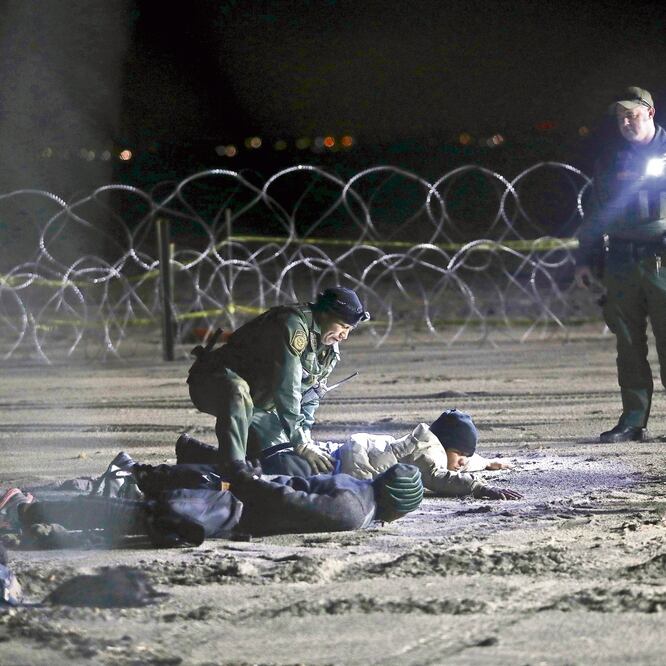 Elementos de la Patrulla Fronteriza al detener ayer a migrantes hondureños, quienes cruzaron desde Tijuana a territorio estadounidense. FÉLIX MÁRQUEZ. AP