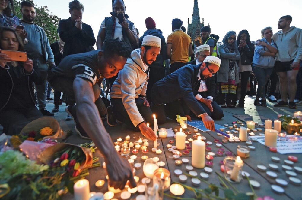 Miles de personas participaron ayer en Manchester en una vigilia en honor a las víctimas del ataque terrorista del lunes en la noche que dejó 22 muertos. (ANDY RAIN. EFE)
