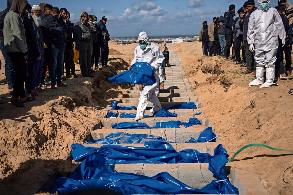 Palestinos entierran los cuerpos de víctimas de los combates con Israel que fueron devueltos a Gaza por el ejército israelí, en un funeral masivo en Rafah. Fatima Shbair | AP