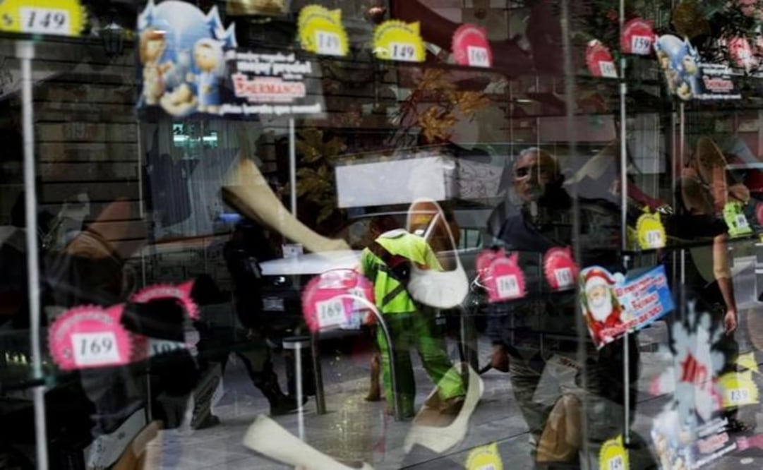 A man is reflected on a window at a shoe shop in downtown Mexico City. (Photo: Reuters)