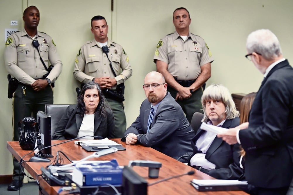 Louis Turpin (sentada al fondo) y David Turpin (segundo de derecha a izquierda), durante su comparecencia ayer en la corte, en Riverside. La pareja decidió presentarse vestida de negro y se declaró no culpable de torturar a sus hijos. (FREDERIC J. BROWN.)