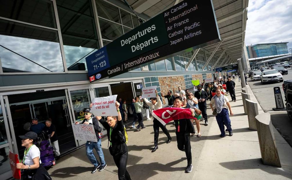 Picketers march around the departures level at the Vancouver International Airport in Richmond, British Columbia, Sunday, Aug. 17, 2025. (Ethan Cairns/The Canadian Press via AP)