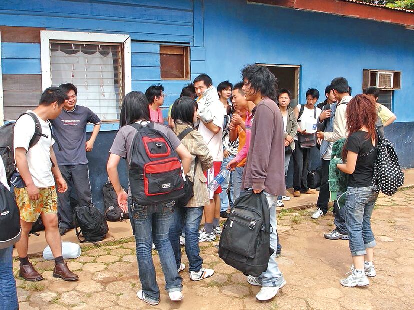 En esta foto cortesía del diario La Prensa, de Nicaragua, migrantes chinos ilegales, que buscaban viajar a Estados Unidos, detenidos en un puerto nicaragüense