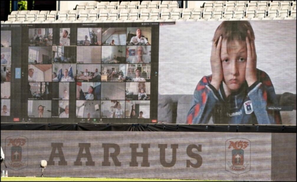 Jugadores ven a los aficionados en pantallas durante partido