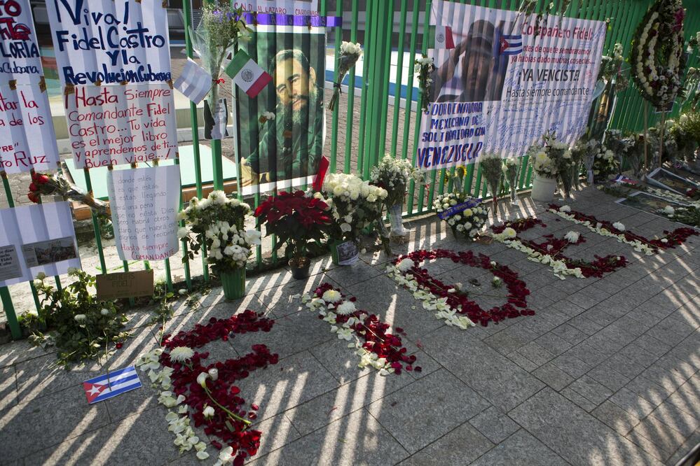 Flower petals spell out Fidel, in front of messages and flowers left by supporters of late Cuban President Fidel Castro, outside the Cuban Embassy in Mexico City, Sunday, Nov. 27, 2016. (AP Photo/Rebecca Blackwell)