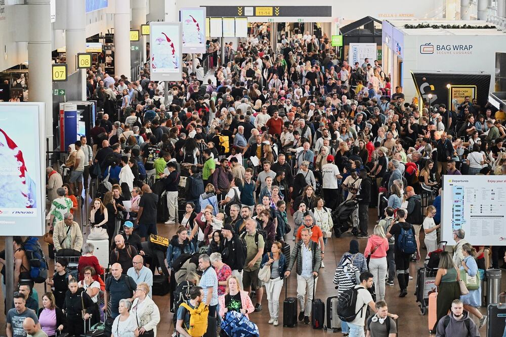 Personas pasan junto a un panel de salidas después de que un ciberataque causara retrasos en el Aeropuerto Internacional de Bruselas en Zaventem, Bélgica. Foto: AP