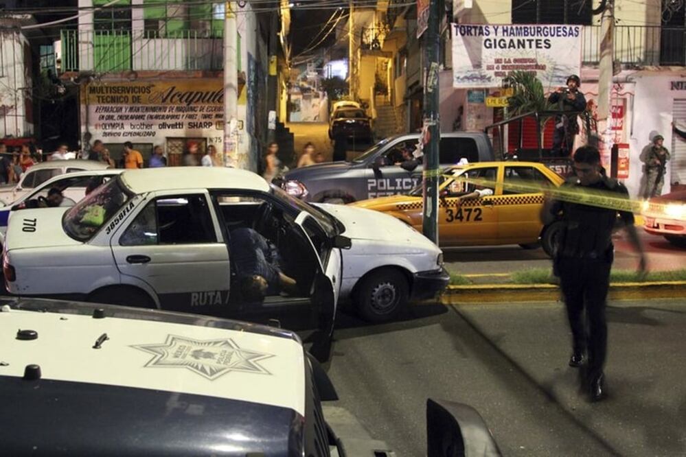 At least five people were killed over the New Year's weekend in the Mexican resort city of Acapulco, including three men found decapitated in a central neighborhood. (AP Photo/Bernandino Hernandez)