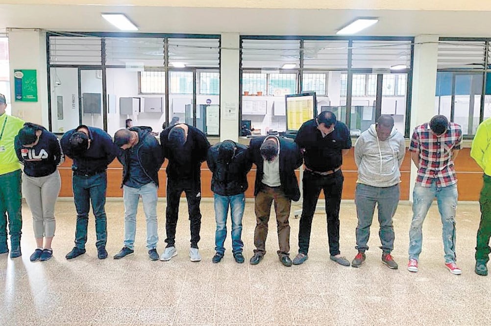 Policías de Colombia custodian a nueve colombianos involucrados en una red de lavado de dinero. Foto: CORTESÍA FISCALÍA GENERAL DE COLOMBIA
