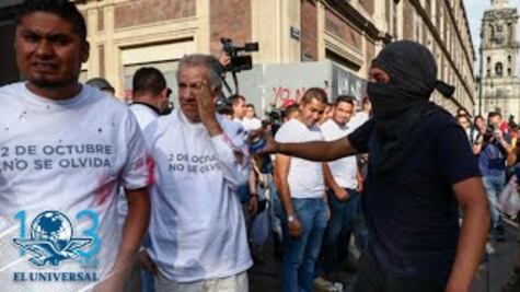 Embozados pintan edificios públicos y lanzan cohetón en marcha por 2 de octubre