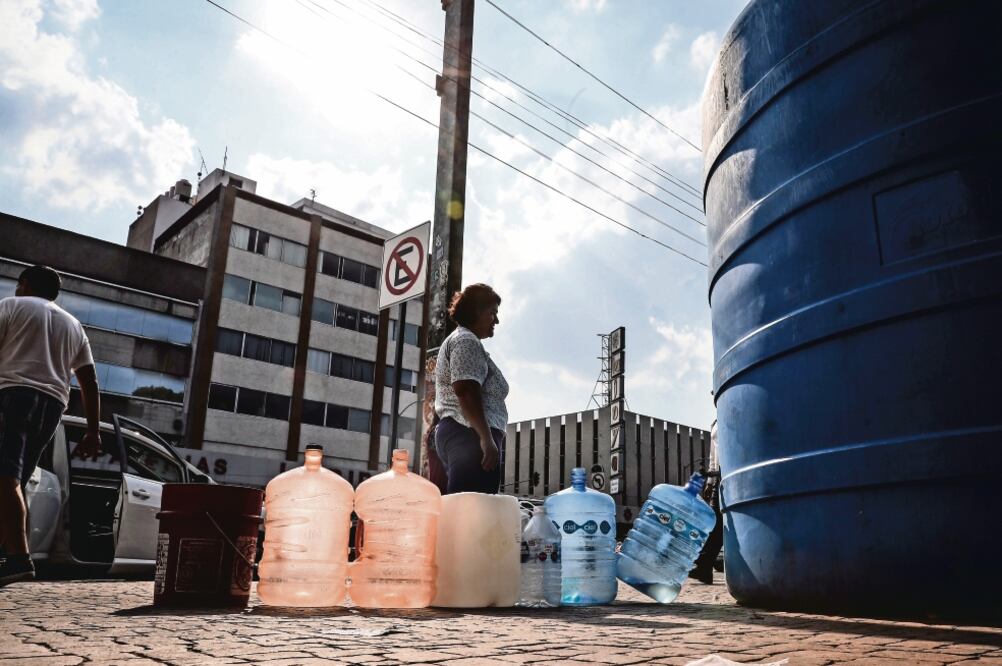 Contingencia. En Santa María la Ribera, ciudadanos siguen extrayendo agua de un tinaco colocado en el Jardín Mascarones. (JUAN CARLOS REYES. EL UNIVERSAL)