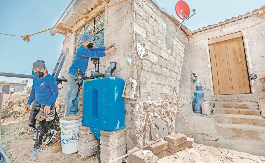 Un integrante de Isla Urbana instala en la Ciudad de México un sistema de recolección de agua pluvial para una familia precaria. Foto: José Méndez. EFE
