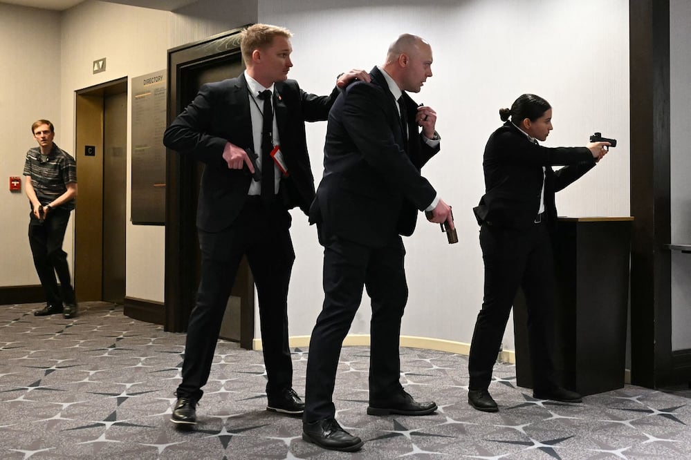 Agentes del Servicio Secreto apuntan sus pistolas tras escucharse diparos, durante la Cena de Corresponsales de la Casa Blanca, en el Hotel Hilton. FOTO: MANDEL NGAN. AFP
