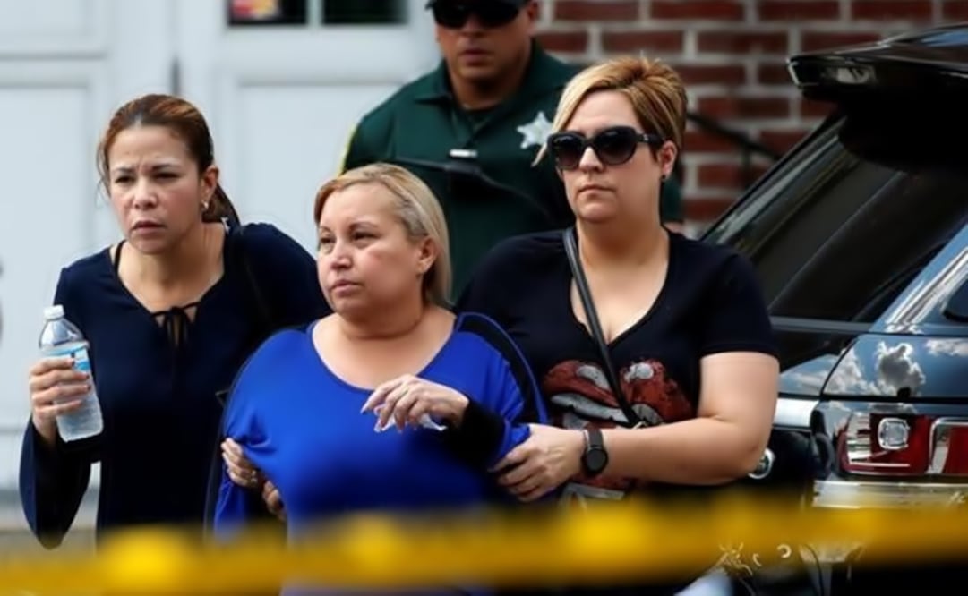Family members help a woman out of a senior citizen's center after being notified of the fate of their loved ones. (Photo: Reuters)