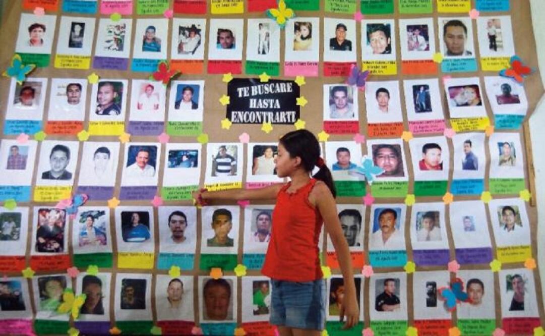 Photos of missing people are included in a mural at Huitzuco's church. (Photo: Salvador Cisneros / EL UNIVERSAL) 