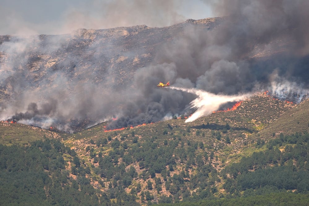 Un avión lanza agua sobre un incendio que avanza cerca de La Adrada, en la provincia española de Ávila. FOTO: MANU FERNÁNDEZ. AP