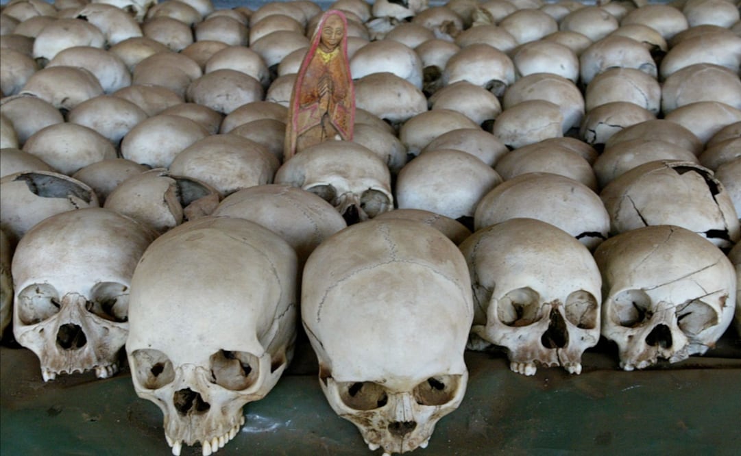 A Christian figure stand between human skulls at the Ntarama church in Nyamata south of Kigali where up to 5,000 people were killed during the 1994 Rwanda genocide - Photo: Karel Prinsloo/AP