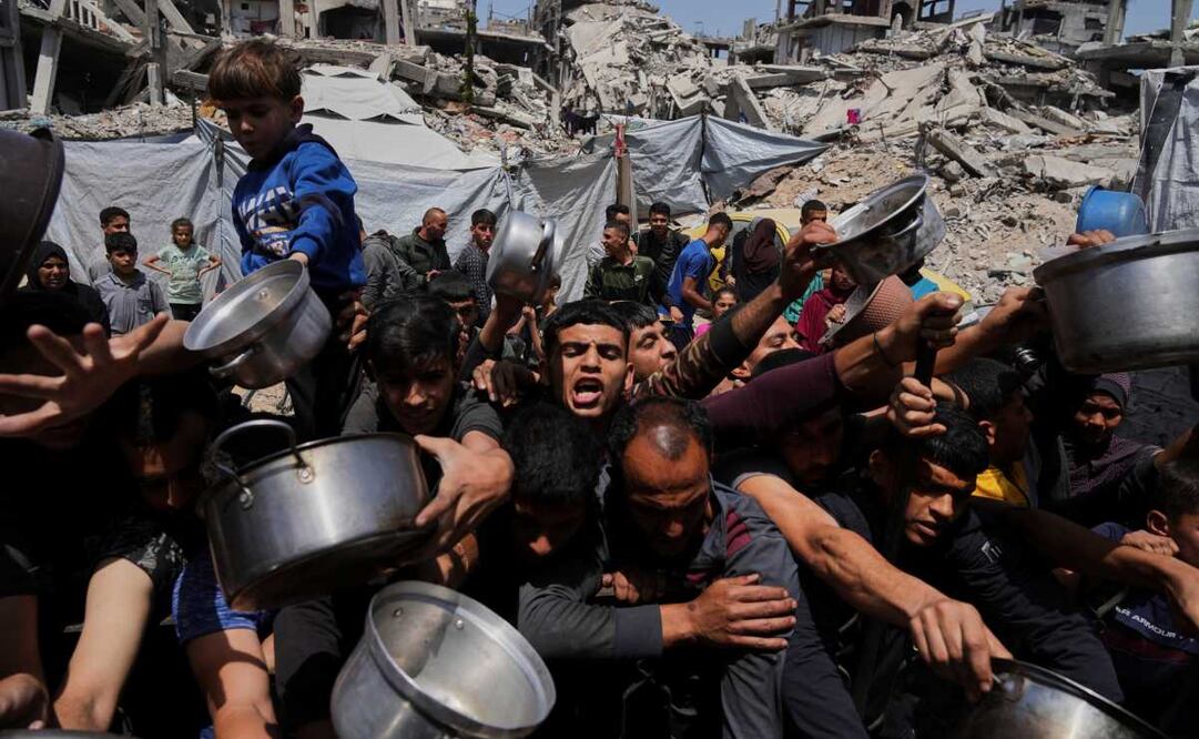 Palestinos luchan por conseguir alimentos donados en una cocina comunitaria en Beit Lahia, al norte de la Franja de Gaza, el 3 de mayo de 2025. Foto: AP