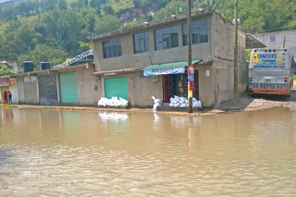 Autoridades municipales repartieron costales con arena para que los vecinos los colocaran en sus viviendas y evitar la entrada de agua de la presa. Foto: JUAN M. BARRERA. EL UNIVERSAL