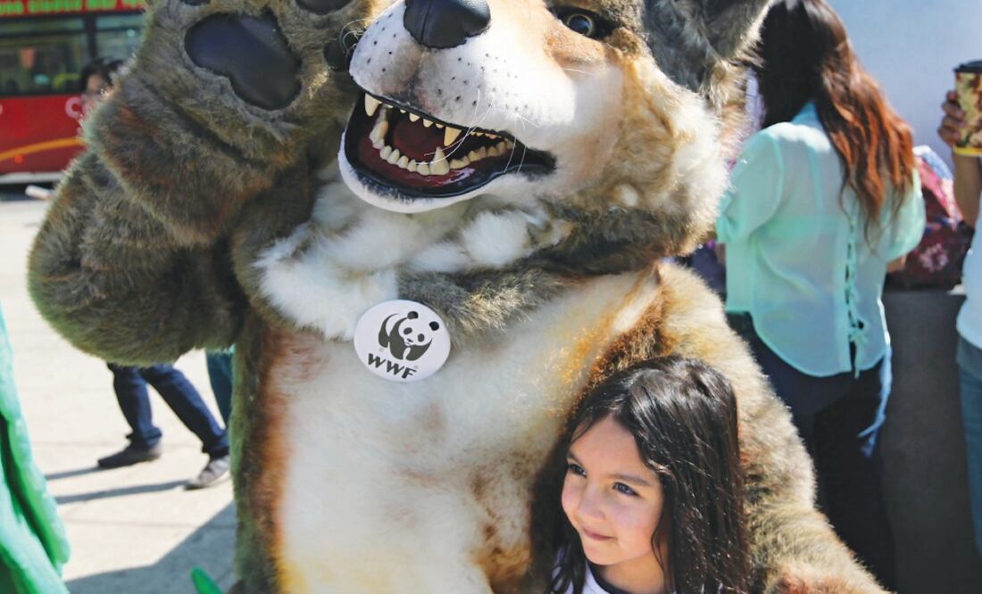 Ecologistas se manifestaron ayer en en el DF en contra del cambio climático. En la foto una niña posa con una persona disfrazada de lobo (Especial)