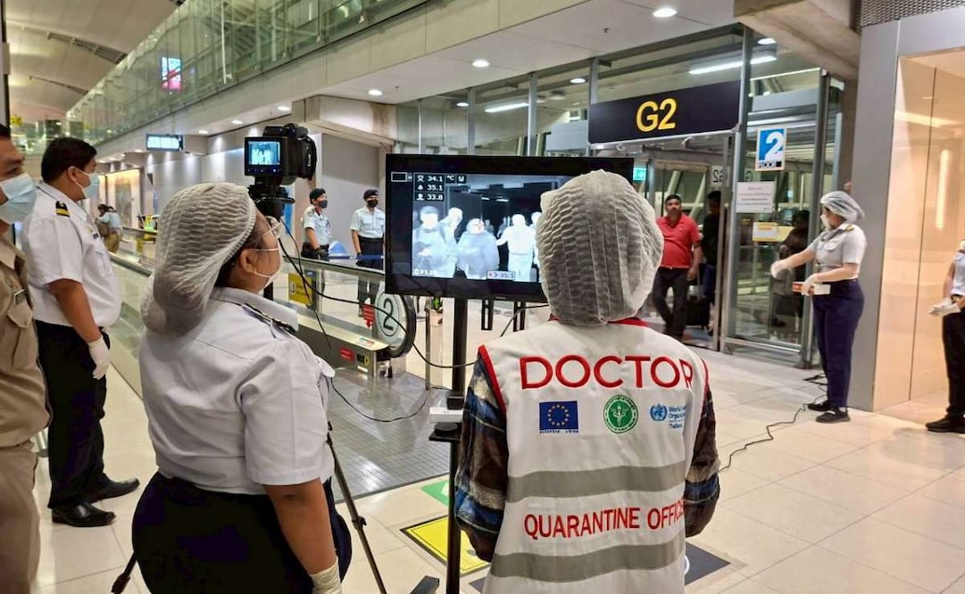 En esta fotografía proporcionada por el departamento de relaciones públicas del Aeropuerto Internacional de Suvarnabhumi, médicos de cuarentena observan el escaneo térmico de viajeros de Bengala Occidental, India, en el Aeropuerto Internacional de Suvarnabhumi en Samut Prakarn, Tailandia, el domingo 25 de enero de 2026. Foto: AP