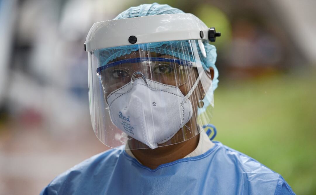 A health worker wears a face mask and shield  - Photo: Luis Robayo / AFP